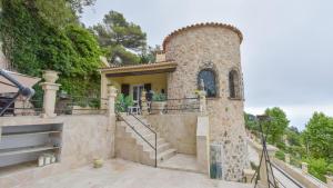 a home in the hills with a stone building at BIRDS EYE VILLA Luxury Castle Paranomic Views of Monaco Monte Carlo Hills & Sea in La Turbie