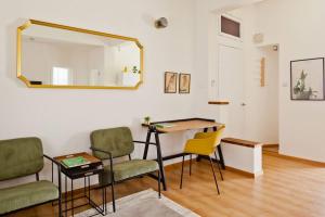 a room with a table and chairs and a mirror at ^Superior 1 BR in the heart of the old north^ in Tel Aviv