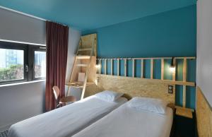 Postel nebo postele na pokoji v ubytování Birgit Hôtel Le Havre Centre