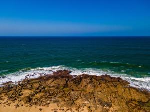 an aerial view of the ocean and a rocky beach at Vista Oceana – 4 Bedroom, Uvongo, Manaba Beach in Margate