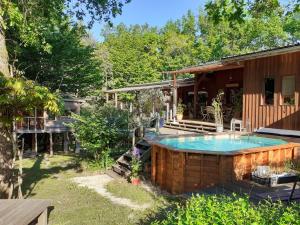 a house with a swimming pool in the yard at La cabane de l'oiseau in Couze-et-Saint-Front