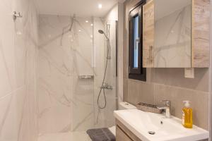 a bathroom with a shower and a sink and a toilet at Anais Apartments in Korinós +53 photos