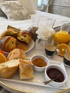 a tray of breakfast foods on a bed at Aux remparts de Montreuil in Montreuil-sur-Mer