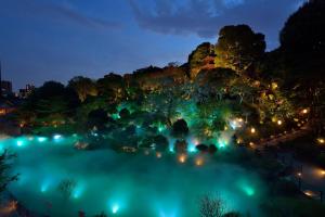 an aerial view of the blue pond at night at Hotel Chinzanso Tokyo in Tokyo
