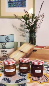 a table with jam and a loaf of bread and books at SA MENDUA E SA PRUNA casa al mare in Iglesias