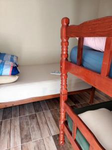 a bunk bed in a room with a ladder at Pousada e Camping Daniel in São Roque de Minas