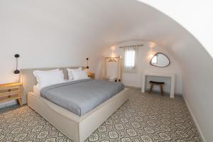 a white bedroom with a bed and a fireplace at AVAL All Suite in Mesaria +37 photos