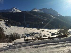 a snow covered hill with mountains in the background at Adventure in Nauders