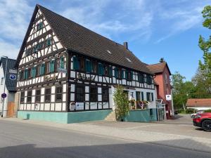 a black and white building on the side of a street at Gasthaus Rössle in Bretzfeld