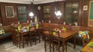 a dining room with wooden tables and chairs at Gasthaus Rössle in Bretzfeld