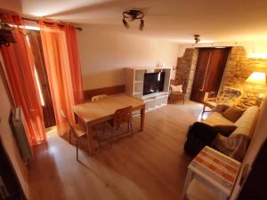 a living room with a couch and a table at La Borda de Pastores in Sabiñánigo