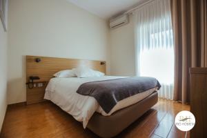 a bedroom with a large bed and a window at Rio Homem in Terras de Bouro