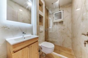 a bathroom with a toilet and a sink and a shower at OLIVE GARDEN APARTMENT in Bar