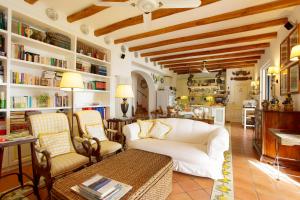 a living room with a white couch and a table at Casa Nostra, stunning, elegant villa in Lipari with pool in Lipari