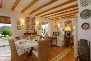 a living room with a table and a dining room at Casa Nostra, stunning, elegant villa in Lipari with pool in Lipari