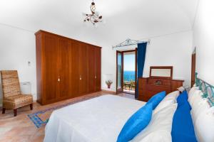 a bedroom with a bed and a couch and a window at Estate4home - Casa Sofia 330 steps in Positano
