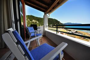 a balcony with chairs and a view of the ocean at Adriatic View Villa in Glyfada