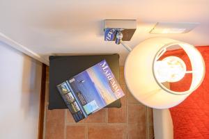 a room with a mirror and a cd on the wall at Residenza Principina in Principina Terra