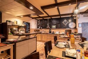 a large kitchen with a table and a counter top at Land-Hotel Zum Schwan, Garni E-Ladestationen, Nähe Phantasialand Nähe Palmenparadies Euskirchen in Weilerswist