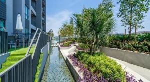 a walkway leading to a building with a garden at Homestay Shah Alam in Shah Alam