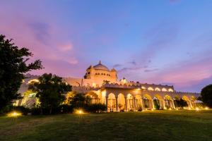 a large building with lights on it at night at Gulaab Niwaas Palace in Pushkar