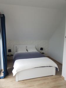 a white bed in a white bedroom with two lamps at Stodoły Koło Wody Niwka in Niwka +27 photos