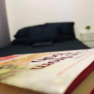 a book sitting on a table in a room at Cozy Bedroom FAME Condo Greenfield EDSA MRT Shaw in Manila +10 photos