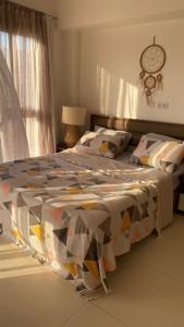 a bedroom with a bed and a clock on the wall at مراسي in El Alamein