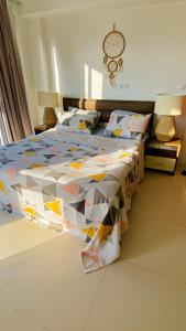 a bed with a colorful quilt on it in a bedroom at مراسي in El Alamein