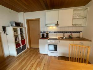 a kitchen with white appliances and a wooden floor at Zur Söhre 