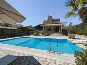 a swimming pool in front of a house at Villa Pietra Bianca - Luxury stay in Puglia in Trani