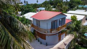 an aerial view of a house with a red roof at Finolhu Dhigurah in Dhigurah