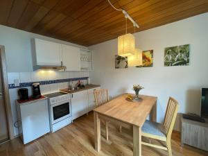 a kitchen with a wooden table and a dining room at Zur Söhre 