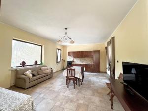 a living room with a table and a couch at Villa Olivia in Tricase