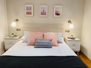 a bedroom with a large bed with two night stands at Apartamento Pereiro Viveiro in Viveiro