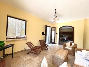 a living room with a couch and chairs and a table at Villa Olivia in Tricase