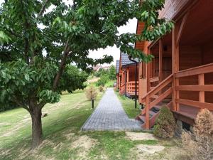 a walkway outside of a house with a tree at Podkarpacka Chata in Iwonicz-Zdrój