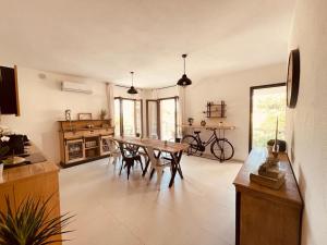 a living room with a wooden table and chairs at B&B Dimora Dorgali in Dorgali