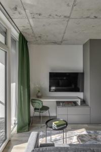 uma sala de estar com um sofá e uma mesa em Urban Jungle Apartments by Reside Baltic em Vilnius