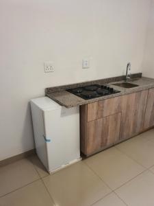 a kitchen with a stove and a sink at BF Dlamini Guest House in Amanzimtoti