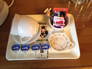 a tray with a plate with chocolates and a bowl at The Lantern Townhouse in Dingle