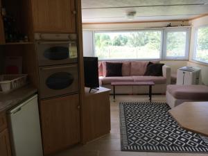 a kitchen with a living room with a couch at Holender nad Saskiem in Kobyłocha +9 photos
