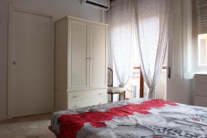 a bedroom with a bed and a cabinet and a window at Casa Pamphili in Rome