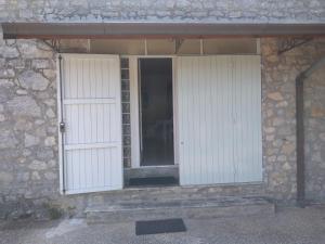 two white doors on a stone building at Casa Maggiali in Portovenere +21 photos