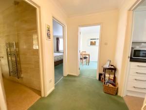 a room with a walk in shower and a kitchen at The Nook in Sidmouth