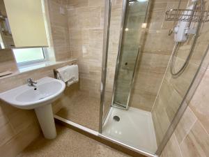 a bathroom with a sink and a shower at The Nook in Sidmouth