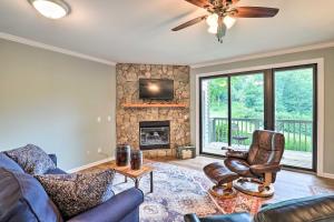 a living room with a couch and a fireplace at Mtn Cabin with Balcony and View in Burnsville! in Burnsville