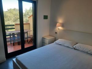 a bedroom with a bed and a view of a balcony at Dolce Relax - Calabria in Catanzaro