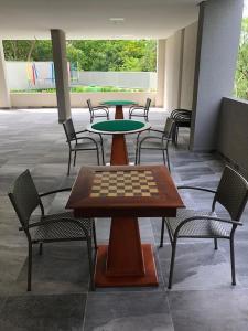 a group of tables and chairs with a chess board on it at Rio Quente Park Veredas Vista paras Piscinas Rio Quente no Fundo esta Liberado in Rio Quente