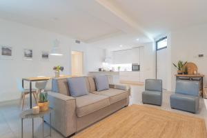 a living room with a couch and a table at Ginepro & Salvia Apartments in Como by Rent All Como in Como